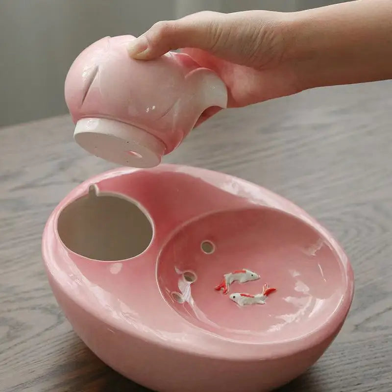 Ceramic pet water fountain with USB pump for cats and other pets to drink water.