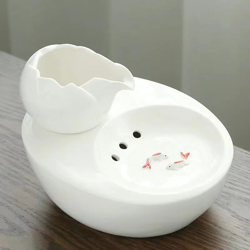 Ceramic pet water fountain with USB pump for cats and other pets to drink water.
